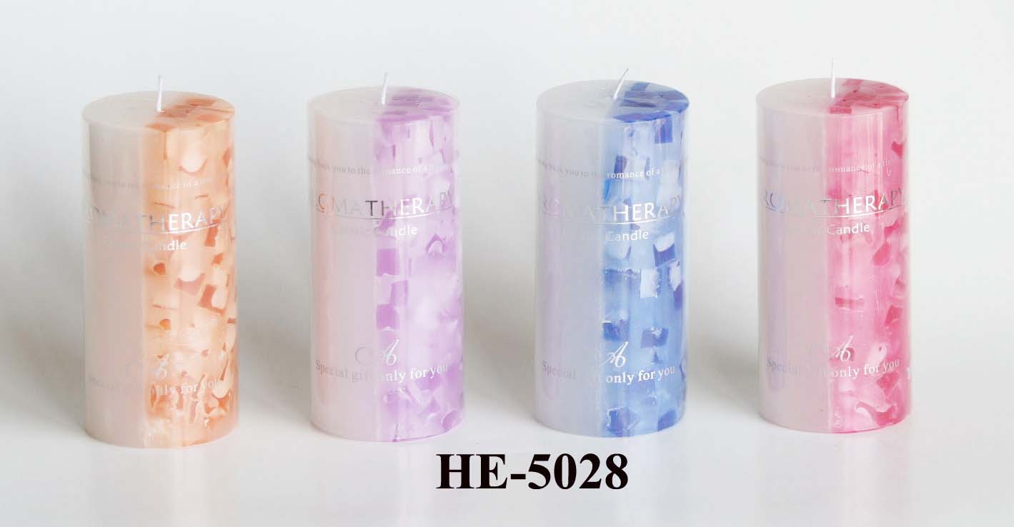 Scented pillar candles with colored wax pieces inside