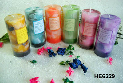 Scented pillar candles with colored wax pieces inside