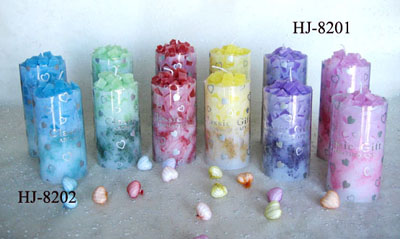 Scented pillar candles with colored wax pieces inside